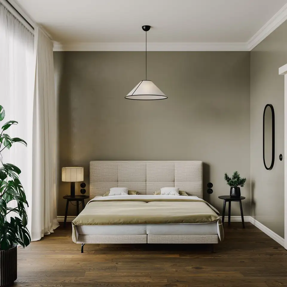 Een boxspring met een geruit gestoffeerd hoofdbord tegen een olijfgroene wand, met een papieren hanglamp en een tafellamp